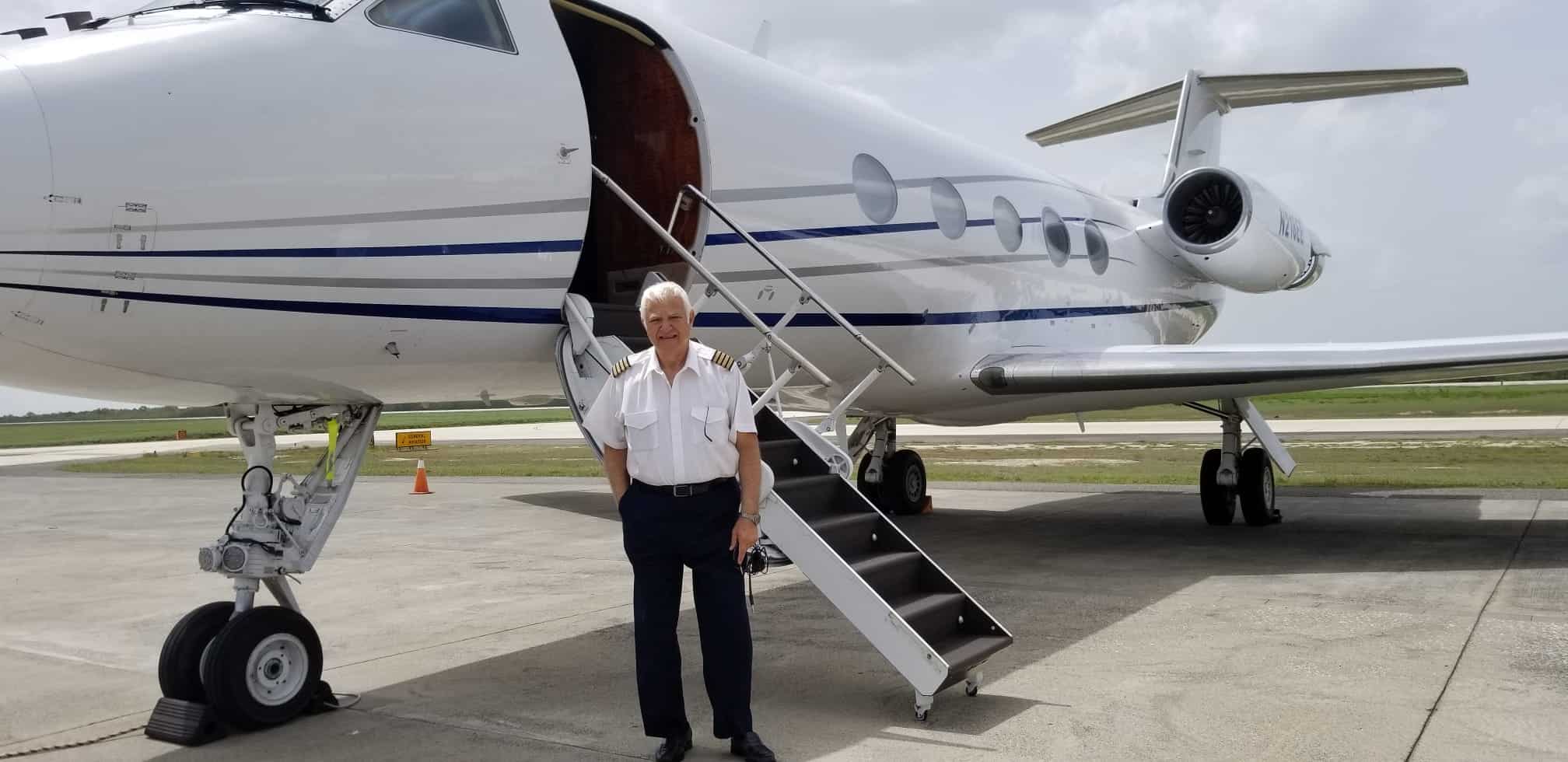 pilot standing by private jet