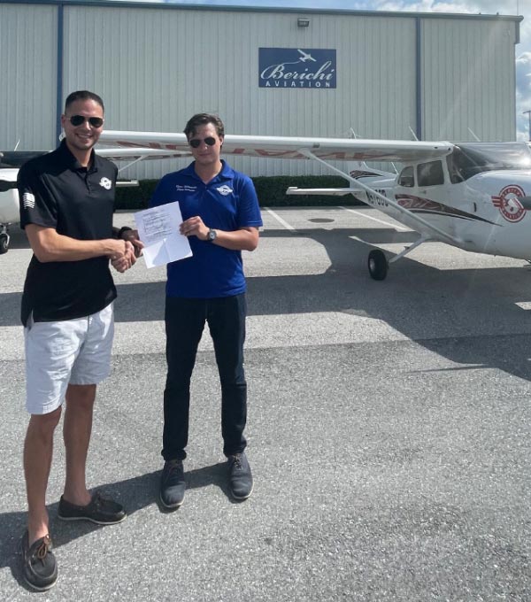 flight instructor shaking hands with newly licensed pilot